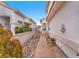 A view of the landscaped side yard, featuring drought-tolerant plants and stone walkways at 3609 Twinbreeze St, Las Vegas, NV 89129