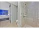 Modern bathroom with a glass shower door, tile walls, and a bedroom visible through an open doorway at 3722 Las Vegas Blvd # 2001, Las Vegas, NV 89158