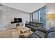 Cozy living room with comfortable leather seating, stylish decor, and a large window offering a cityscape view at 3722 Las Vegas Blvd # 2001, Las Vegas, NV 89158