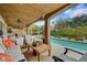 Relaxing backyard with covered patio, outdoor seating, a swimming pool, lush landscaping, and privacy at 3723 Robin Knot Ct, North Las Vegas, NV 89084