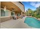 This backyard features a private pool, covered patio, outdoor seating, and manicured landscaping at 3723 Robin Knot Ct, North Las Vegas, NV 89084