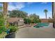 Private backyard with a pool, spa, built-in BBQ, and lush landscaping providing an ideal outdoor living space at 3723 Robin Knot Ct, North Las Vegas, NV 89084