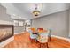 Cozy dining room with a fireplace, wood floors, and stylish lighting, creating an inviting atmosphere at 3723 Robin Knot Ct, North Las Vegas, NV 89084