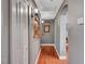 View of the hallway with hardwood floors, neutral walls, art, and an arched entryway that adds architectural interest to the home at 3723 Robin Knot Ct, North Las Vegas, NV 89084