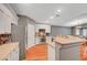 Open kitchen with granite countertops, stainless steel appliances, and ample cabinet space for storage at 3723 Robin Knot Ct, North Las Vegas, NV 89084