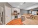 Bright kitchen featuring granite countertops, stainless steel appliances, and wood flooring at 3723 Robin Knot Ct, North Las Vegas, NV 89084