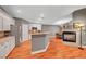Open-concept kitchen features white cabinets, stainless steel appliances, and adjacent dining area with a fireplace at 3723 Robin Knot Ct, North Las Vegas, NV 89084