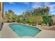 Backyard featuring a private pool, hot tub, lush landscaping, and a tranquil outdoor oasis for relaxation and entertainment at 3723 Robin Knot Ct, North Las Vegas, NV 89084