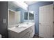 Bright bathroom featuring a double sink vanity with modern fixtures and a large mirror at 3915 Enchanted Wells Ave, North Las Vegas, NV 89031