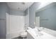 Modern bathroom with a tub-shower combination and ample vanity space offers a clean and functional design at 3915 Enchanted Wells Ave, North Las Vegas, NV 89031