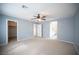 Large bedroom offers plush carpeting, a ceiling fan, and easy access to a walk-in closet and bathroom at 3915 Enchanted Wells Ave, North Las Vegas, NV 89031