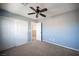 Well-lit blue bedroom with a ceiling fan and closet space provides a cozy and functional living space at 3915 Enchanted Wells Ave, North Las Vegas, NV 89031