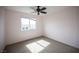 Bright bedroom with a ceiling fan and window, filled with natural light, offers a peaceful and inviting space at 3915 Enchanted Wells Ave, North Las Vegas, NV 89031