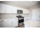 Bright kitchen features stainless steel appliances, white cabinets, and stone countertops at 3915 Enchanted Wells Ave, North Las Vegas, NV 89031