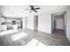 Bright living room with hardwood floors and neutral decor, seamlessly connected to a modern kitchen at 3915 Enchanted Wells Ave, North Las Vegas, NV 89031