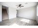 An open-concept living room featuring hardwood floors, neutral decor, and a staircase at 3915 Enchanted Wells Ave, North Las Vegas, NV 89031