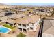 An aerial view displays a two-story home featuring a patio, balcony, brick paved yard, and artificial turf at 397 American Dipper St, Las Vegas, NV 89138