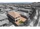 Stunning aerial view of two-story home with a patio, balcony, and a brick paved yard with a patch of green grass at 397 American Dipper St, Las Vegas, NV 89138