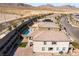 Two-story home aerial showcasing patio, balcony, brick paved yard, and artificial turf, surrounded by desert landscape at 397 American Dipper St, Las Vegas, NV 89138