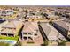 Aerial view of a two-story home with patio, balcony, brick paved yard, and artificial turf, nestled in a neighborhood at 397 American Dipper St, Las Vegas, NV 89138