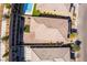 An aerial shot displays a two-story home with a patio, balcony, brick paved yard, and artificial turf at 397 American Dipper St, Las Vegas, NV 89138