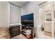 Cozy bedroom featuring dark wood furniture, a television, and an en-suite bathroom at 397 American Dipper St, Las Vegas, NV 89138