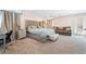 Spacious bedroom featuring a tufted headboard, sitting area and neutral decor throughout at 397 American Dipper St, Las Vegas, NV 89138