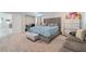 Stylish bedroom is complete with a sitting area, decor, and a tufted headboard at 397 American Dipper St, Las Vegas, NV 89138