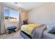Bright bedroom featuring a large window, desk, and comfortable bed with gray and yellow accents at 397 American Dipper St, Las Vegas, NV 89138