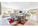 Bright dining room with a long table, tile floors, and backyard view from big window at 397 American Dipper St, Las Vegas, NV 89138