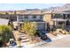 Charming two-story home with a stone walkway, desert landscaping, and a gray two-car garage at 397 American Dipper St, Las Vegas, NV 89138