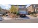 Charming two-story home showcasing a desert landscape and a two-car garage at 397 American Dipper St, Las Vegas, NV 89138