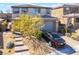Charming two-story home with a well-manicured front yard, a stone walkway, and a gray two-car garage at 397 American Dipper St, Las Vegas, NV 89138