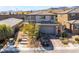 Charming home with a stone walkway, desert landscaping, and a gray two-car garage at 397 American Dipper St, Las Vegas, NV 89138