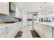 A bright kitchen featuring white cabinets, tile backsplash, and a large island at 397 American Dipper St, Las Vegas, NV 89138