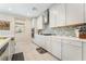 Kitchen with stainless steel appliances, white cabinets, and tile backsplash at 397 American Dipper St, Las Vegas, NV 89138