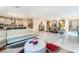 Inviting open floor plan with kitchen view, sleek tile flooring and stylish white couch at 397 American Dipper St, Las Vegas, NV 89138