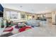Bright, open living room with tile floors, white sofa, and an open view of kitchen at 397 American Dipper St, Las Vegas, NV 89138