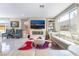 Bright living room features a sleek modern fireplace, plush white sofa, and lots of light at 397 American Dipper St, Las Vegas, NV 89138