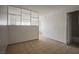 Spacious living room with neutral walls, tile flooring, and bathroom access at 4600 University Center Dr # 99, Las Vegas, NV 89119
