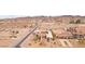 Wide angle view of desert community with homes nestled amongst rolling hills on a sunny day at 519 N Racetrack Rd, Henderson, NV 89015