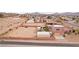 Aerial view of desert community with homes nestled amongst rolling hills under cloudy sky at 519 N Racetrack Rd, Henderson, NV 89015