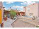 Spacious backyard featuring a modern pool, desert landscaping, and a charming patio area, ideal for outdoor living at 519 N Racetrack Rd, Henderson, NV 89015