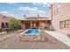 Picturesque backyard with a sparkling pool, covered patio, and desert landscaping, creating a serene outdoor oasis at 519 N Racetrack Rd, Henderson, NV 89015