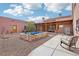 Beautiful backyard featuring a modern pool, shaded patio, and desert landscaping, perfect for relaxing and entertaining at 519 N Racetrack Rd, Henderson, NV 89015