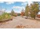 Spacious backyard featuring natural desert landscaping, a fire pit, and mature trees at 519 N Racetrack Rd, Henderson, NV 89015