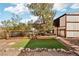 Property features rustic backyard area, a wooden fence and decorative wagon wheel at 519 N Racetrack Rd, Henderson, NV 89015