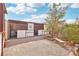 Rustic backyard features animal enclosure and quaint sitting area beneath shady tree at 519 N Racetrack Rd, Henderson, NV 89015
