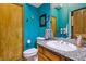 Bright bathroom featuring granite countertop, wood cabinets, and a classic white toilet and sink at 519 N Racetrack Rd, Henderson, NV 89015
