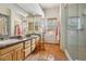 Bright bathroom features a double vanity and a glass enclosed shower at 519 N Racetrack Rd, Henderson, NV 89015